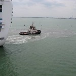 Ships maneuvering to enter or back out of their berths also create massive suction, as the brown sediment churned up here attests.