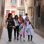 Some of the girls are looking pretty effervescent, even if they do have to sherpa backpacks that are bigger and heavier than they are. And that they have to wear the anonymous smock, which is required. Cheaper than a uniform, and nobody seems to mind wearing it down the street in public.