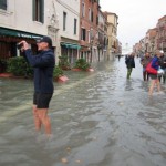 As you see, not everybody got the memo that the city was afflicted with a desperate situation.  This is Venice with acqua alta: People waist-deep in the Piazza San Marco carrying their suitcases on their heads, people sitting in cafes as the water laps at their chairs, and some people (they were French, for the record) who think it's all more fun than seeing elephants on a roller-coaster.  So take your pick.  Tragedy?  Comedy?  Just more work?