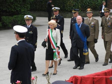 (Left to right, excluding officer with back turned): Adm. Mario Fumagalli, Chief Commandant of the Navy in the Adriatic, based at the Venice Arsenal; Annamaria Giannuzzi Miraglia, city councilor for Education, whose sash in the national colors indicates she is representing the mayor; man with blue sash represents the President of the Province of Venice; (behind them, left to right) Rear Admiral; Brigadier General of the Air Force; General of the Carabinieri; another officer of the Carabinieri
