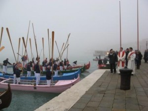 A homemade version of the alzaremi -- the crews are giving the traditional raised-oar salute in response to the blessing of their caorlinas before a race in December.