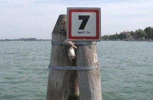One of many signs in the lagoon notifying boaters of the speed limit, here in the Canale delle Scoasse along the Lido.  Note that the speed is given in kilometers (not knots) per hour.  If anyone is going this slowly it's either because he's just spotted a policeman up ahead, or his motor has died and he's being towed.